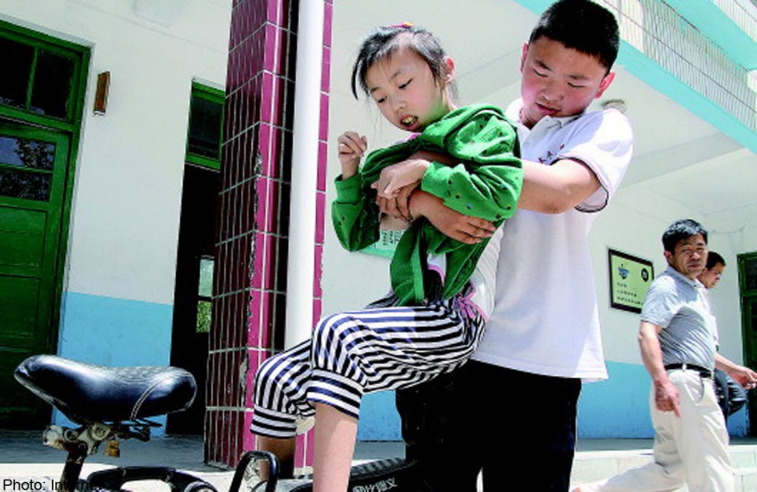 Afflicted with arthritis since 9, brother carries her to school for 7 years