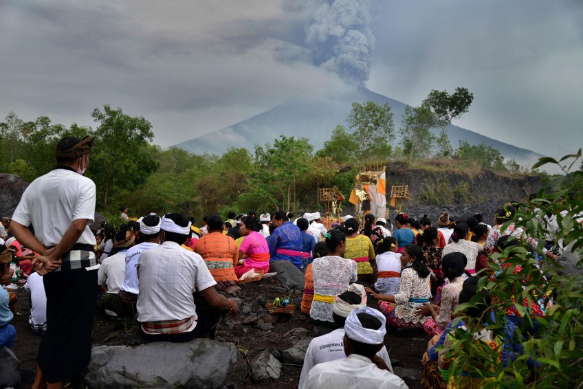 Balinese offer prayers as rumbling volcano threatens tourism lifeblood 