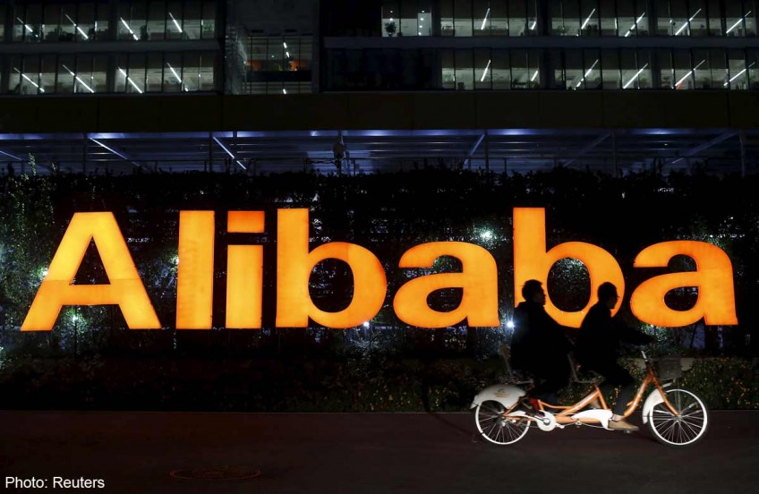 Alibaba quarterly net profit halved, announces CEO change