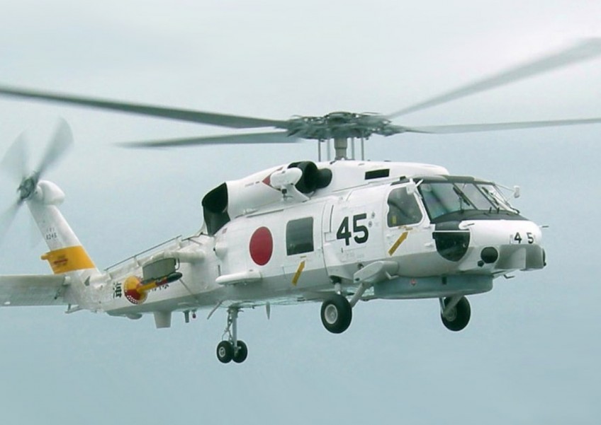 2 Japan navy helicopters crash, 1 body found, 7 missing
