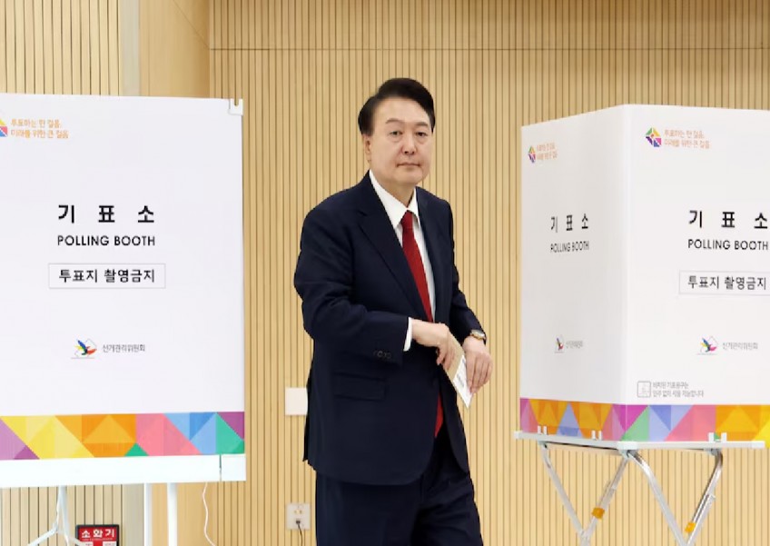 South Korea's Yoon joins early voting ahead of parliamentary elections