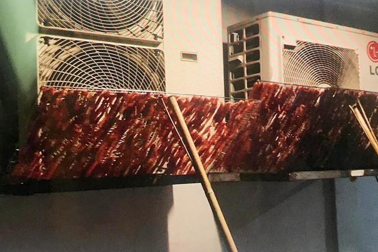 Shock in Beach Road: Raw meat dried on air-con vent outside HDB flat