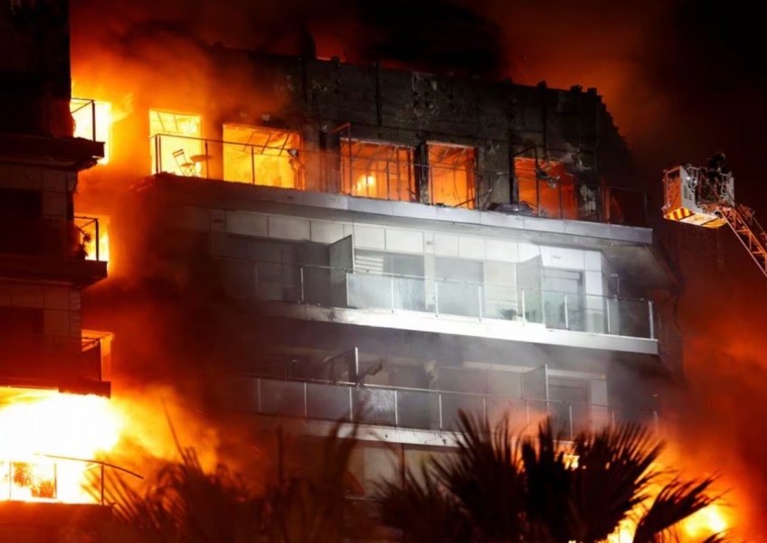 Spanish firefighters battle blaze engulfing apartment building in Valencia