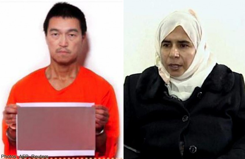 Japan says working towards freeing hostage and Jordan pilot 