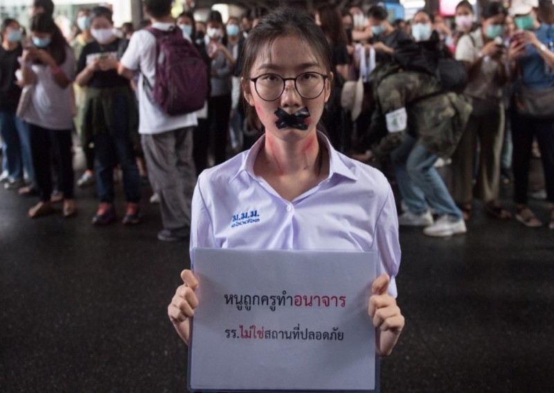 Thai police arrest student after king's portraits defaced