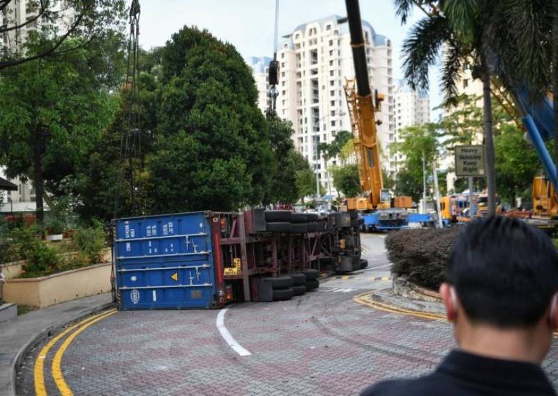 Container truck overturns on narrow Bedok road it shouldn't have entered