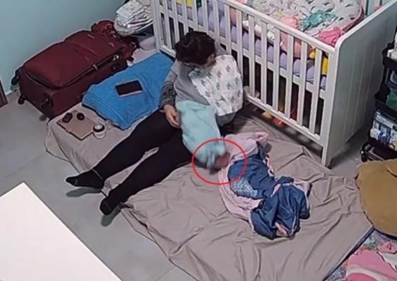 Confinement nanny caught dragging month-old baby by the leg and falling asleep on the job