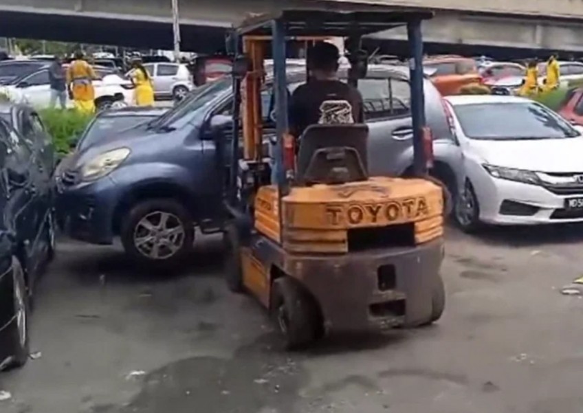 'I have a business to run': Malaysian man uses forklift to remove parked cars blocking his shop