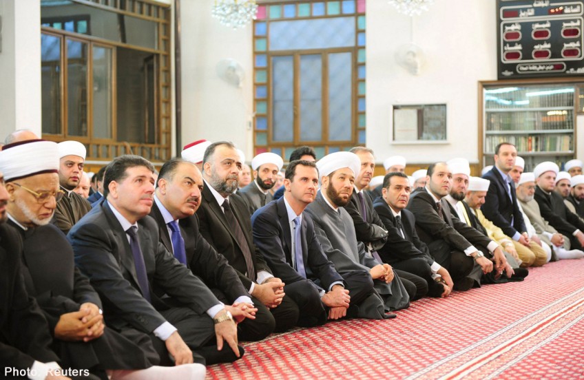 Syria's Assad joins prayers to mark end of Ramadan