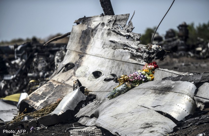 MH17 crash: Plane takes more remains as Malaysians join probe