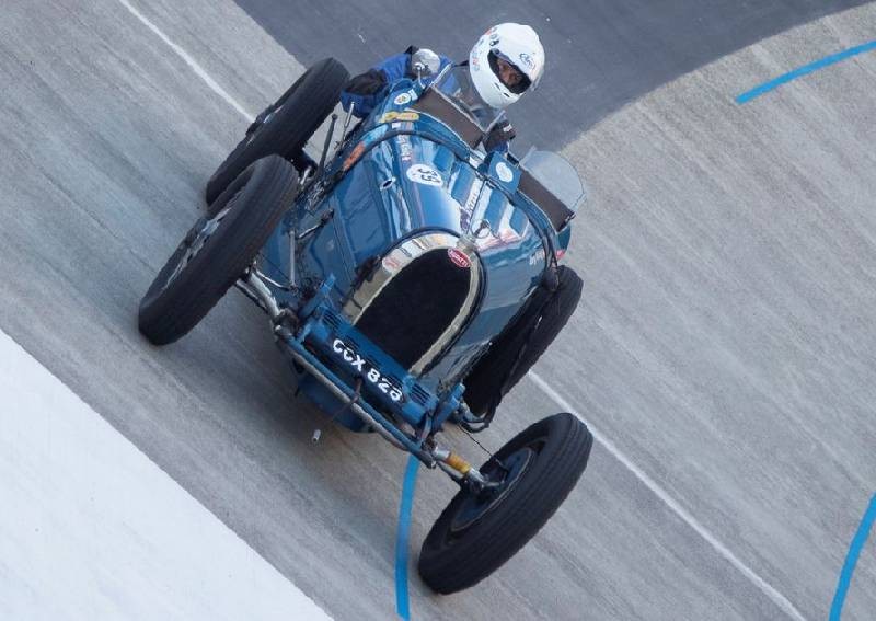 Vintage race cars and bikes compete on banked Swiss track