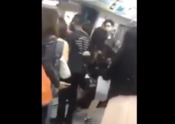 2 women fight and scream at each other until 1 gets pushed out of train