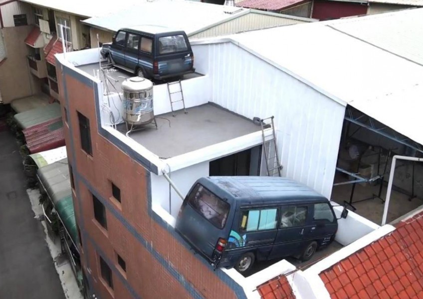 No joke: Man in Taiwan parks vans on rooftop to avoid fines
