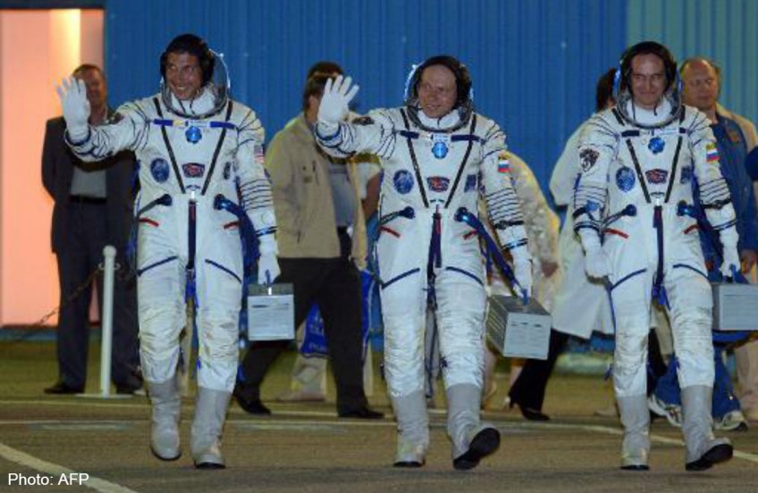 American, two Russians back on Earth after half-year in space