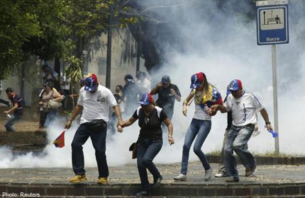 Venezuela death toll rises to 34 as troops and protesters clash