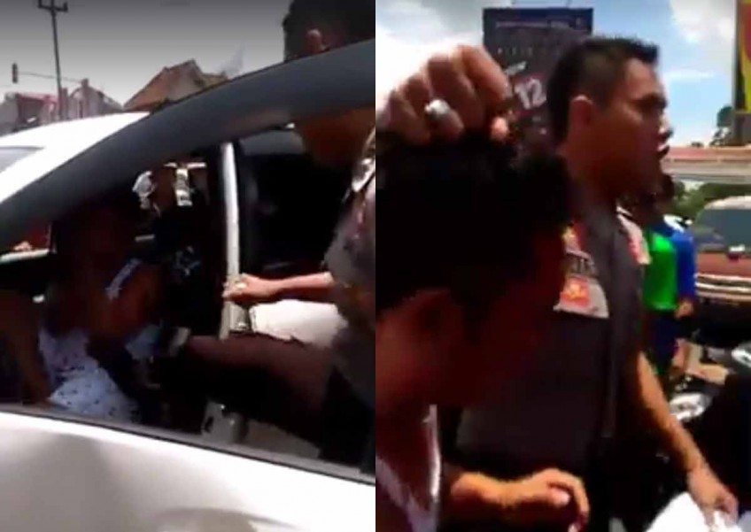 Policeman in Indonesia seen hitting and kicking reckless driver who was beaten up by mob