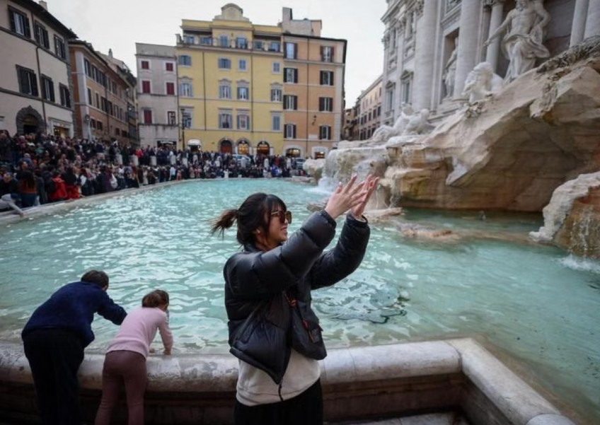 Coins tossed into Rome's Trevi Fountain carry more than tourists' wishes
