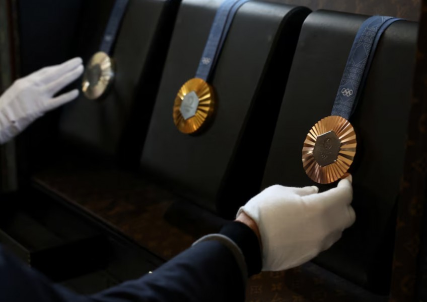 Louis Vuitton makes custom trunks for Paris Games flames, medals