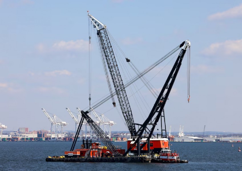Massive crane put in place to clear Baltimore bridge debris as crews assess damage
