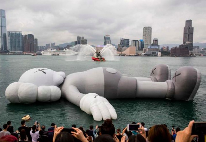 Giant floating Kaws sculpture arrives in Hong Kong harbour