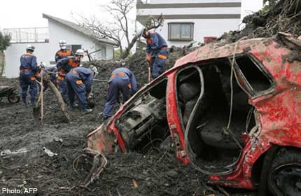 Dozens leave Japan mudslide island to beat new typhoon