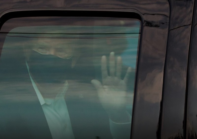 Infected Trump greets supporters in motorcade outside hospital; his health unclear