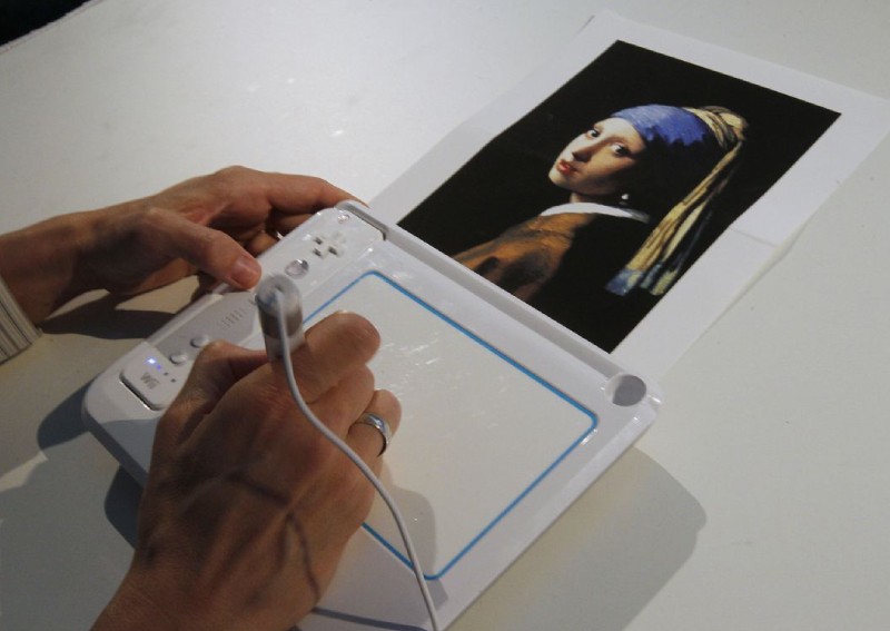 Activist glues his head to 'Girl with a Pearl Earring' painting in The Hague