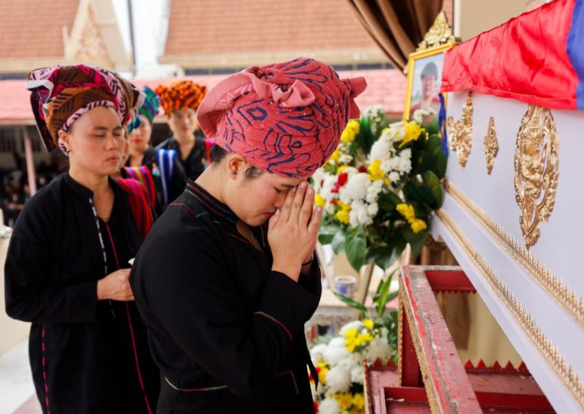 Thai mall shooting victim's mother bids emotional farewell at cremation