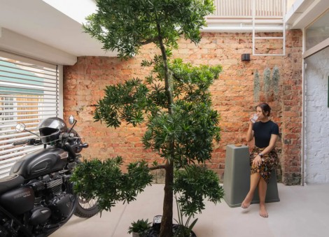Inside a 1940s shophouse unit with a rustic motorcycle garage