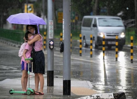 Flood warnings issued as heavy rain drenches Singapore, causes delays at Changi Airport